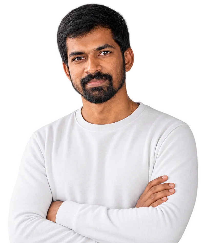 Portrait of Haribaskar Dhanabalan in a white sweater with his arms crossed